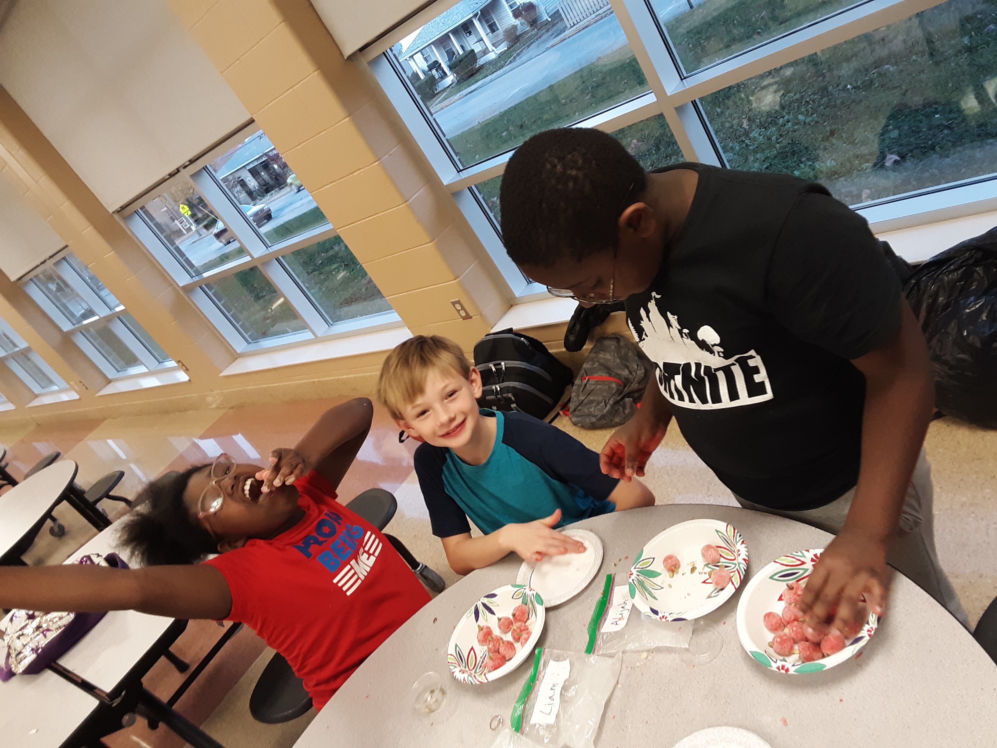 Man doing crafts with kids at table