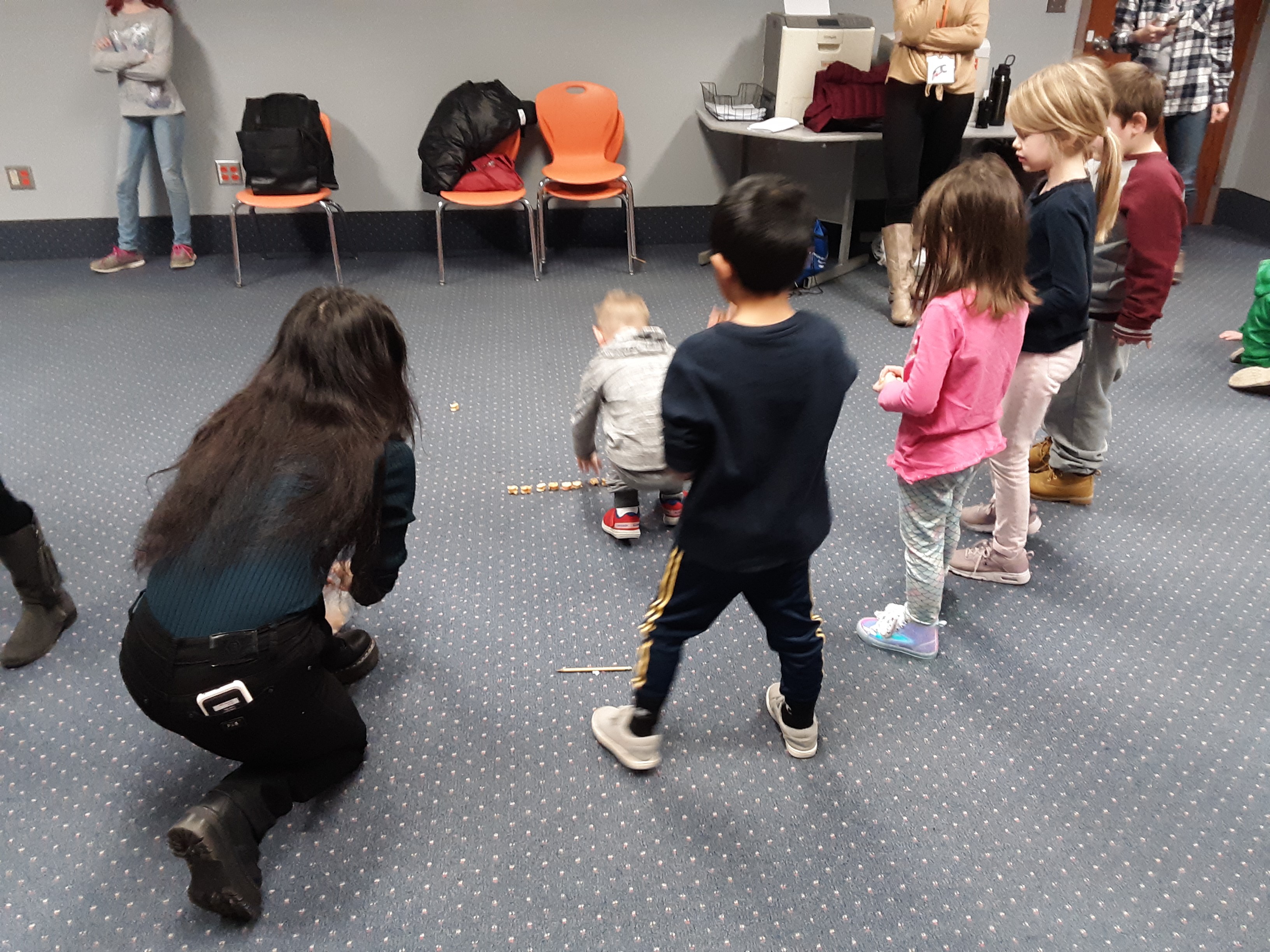 Woman doing activity with kids in a room