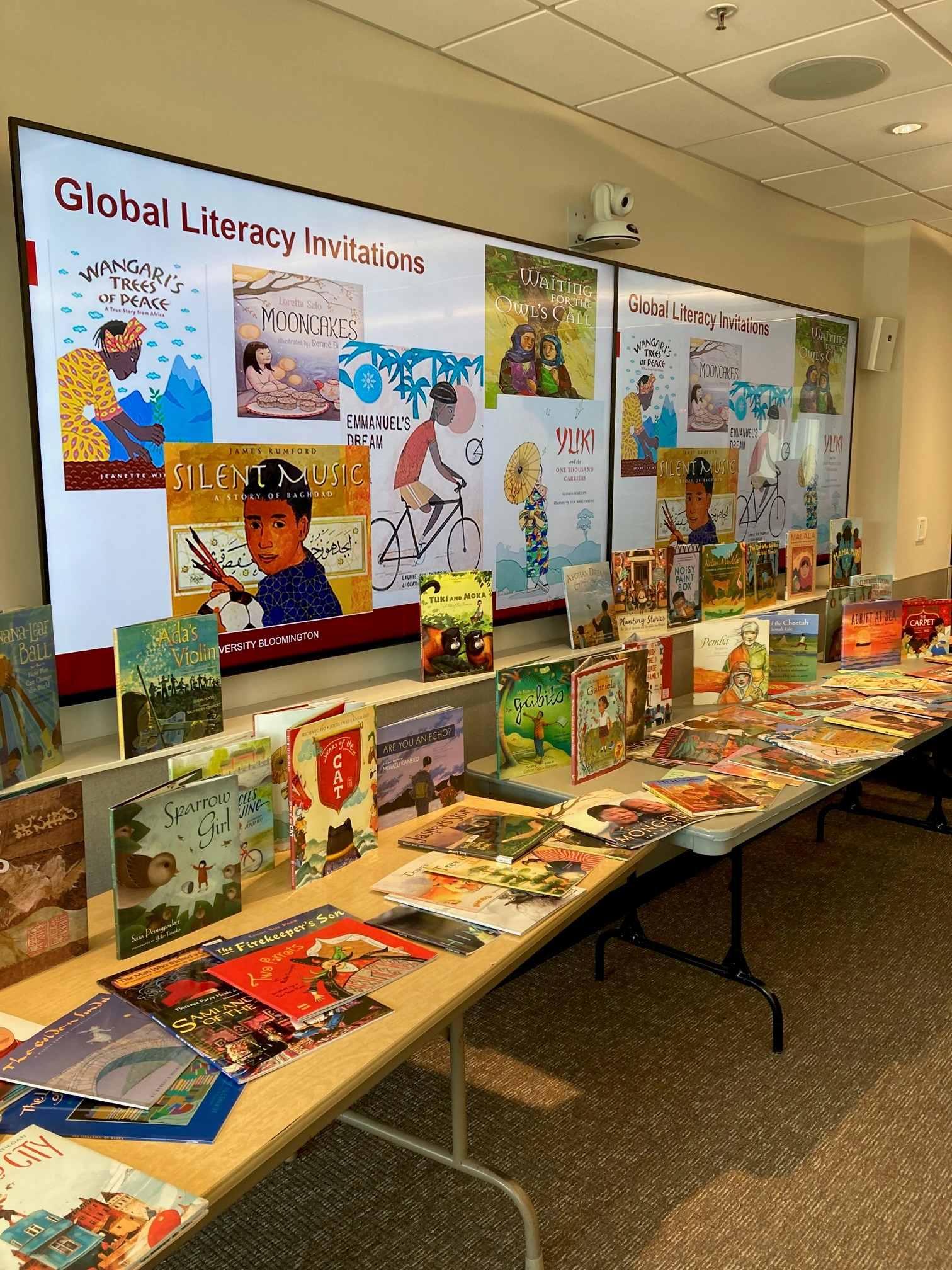 Books and materials are laid out for the Global Literacy Invitation.