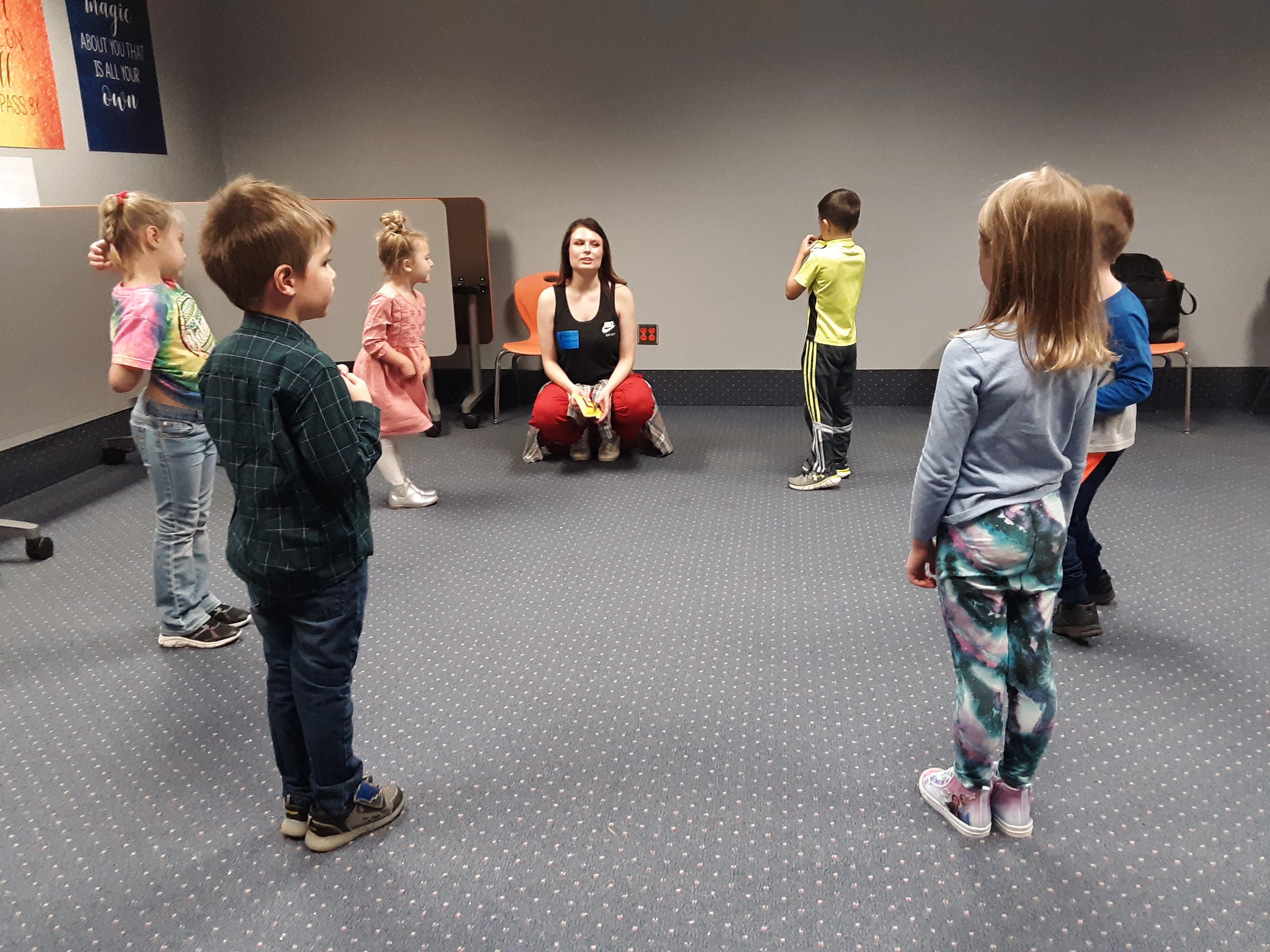 Woman talking to kids in a circle