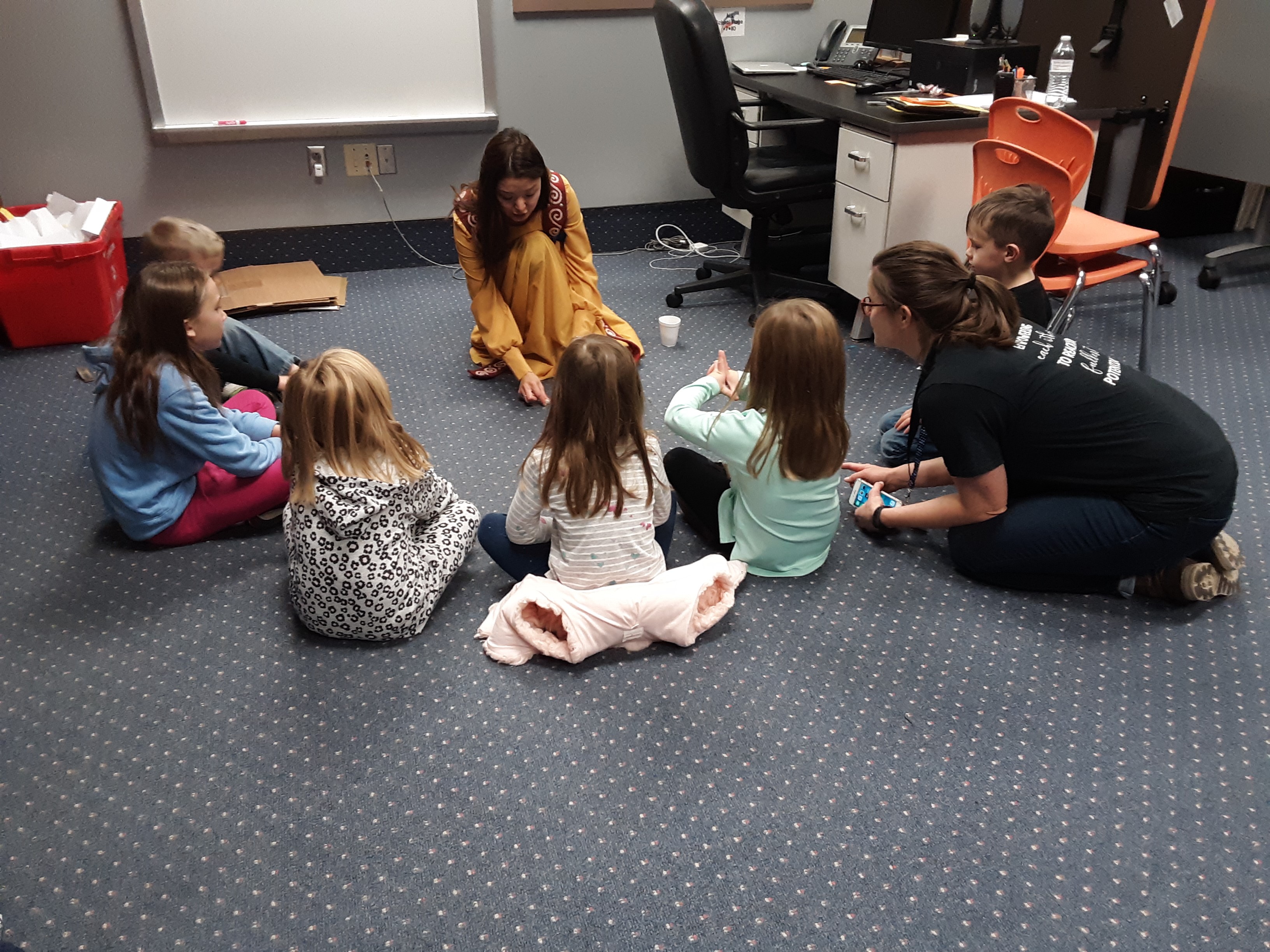 Woman doing activity with group of children